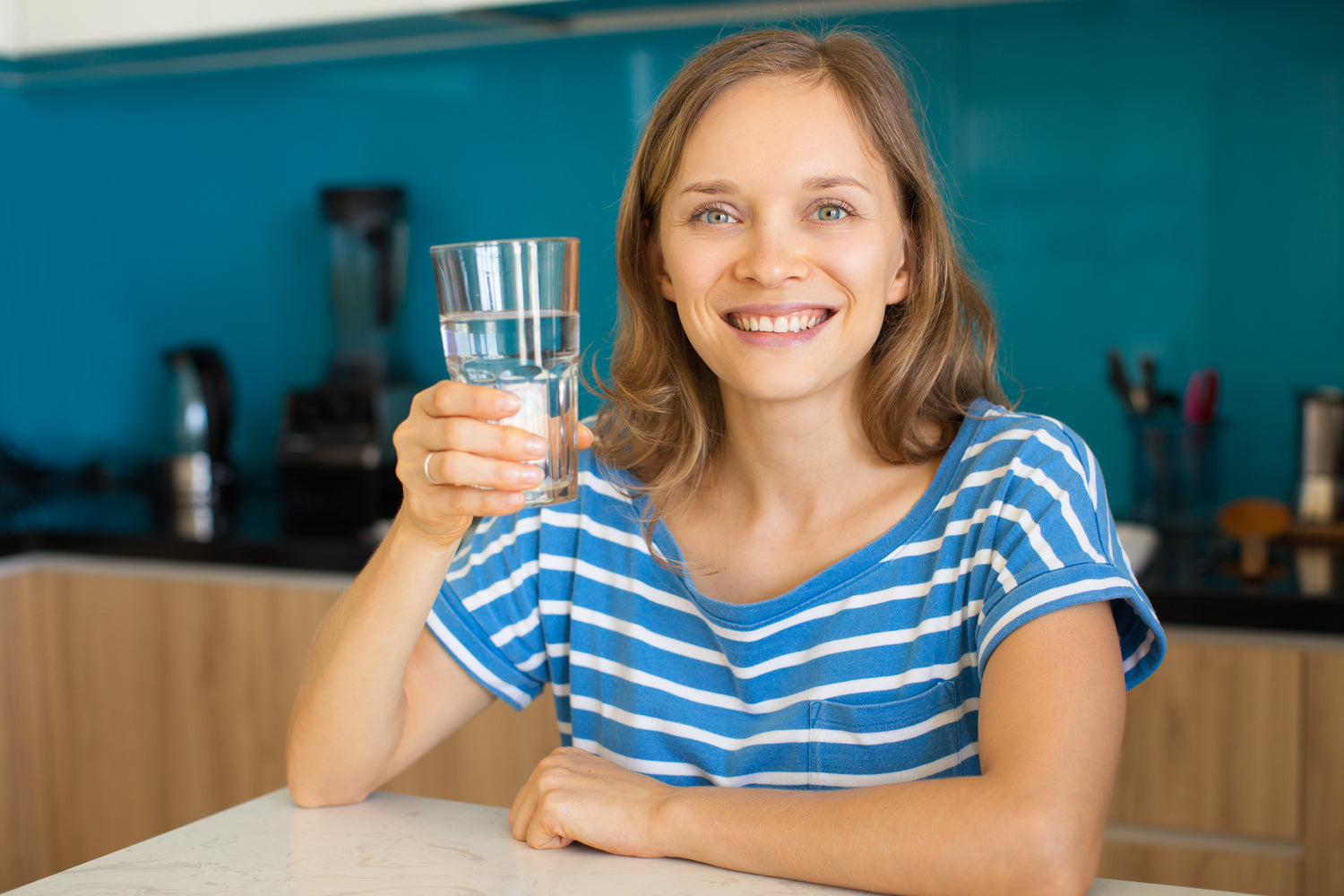 Happy Woman with a Glass of Water